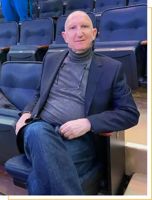 A man sitting in an empty stadium seat.